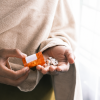 A woman taking overdose medications. Image credit: Unsplash