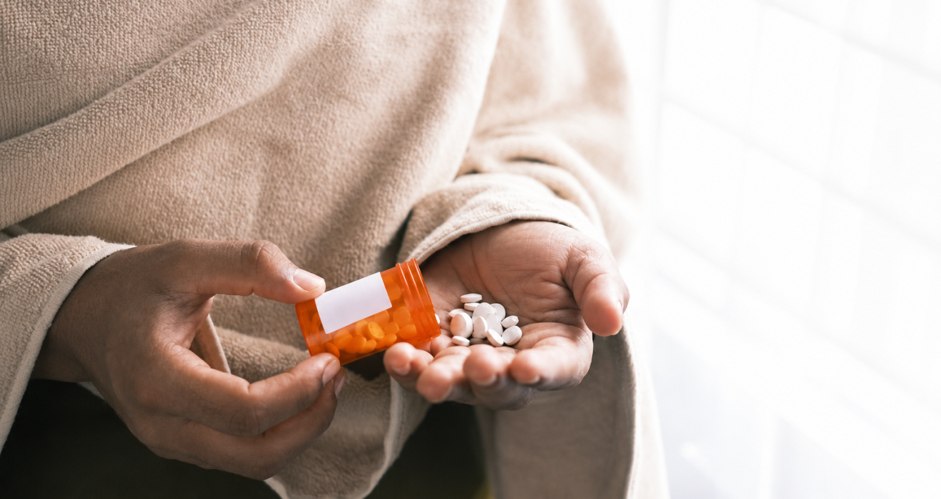 A woman taking overdose medications. Image credit: Unsplash
